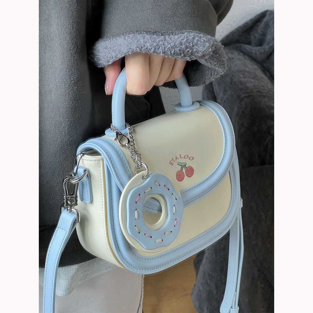 Hand-held shoulder saddle bag